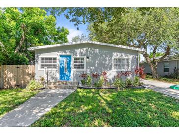 Charming home with a blue front door, landscaped garden, and inviting walkway at 4460 67Th N St, St Petersburg, FL 33709
