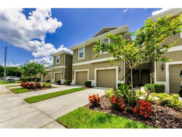 Inviting townhomes featuring well-maintained landscaping, covered entries, and attached one-car garages at 2119 Broadway View Ave, Brandon, FL 33510