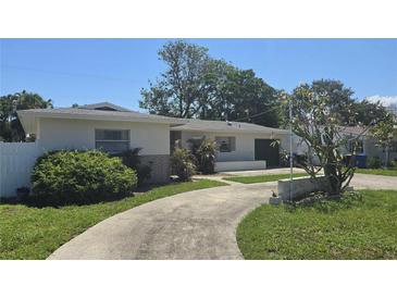 Charming single story home with a driveway and well-maintained landscaping at 2502 Tropical Shores Se Dr, St Petersburg, FL 33705