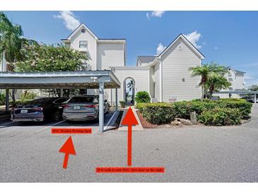 Exterior view of parking area with covered parking and walkway to unit at 3127 W Sligh Ave # 101C, Tampa, FL 33614