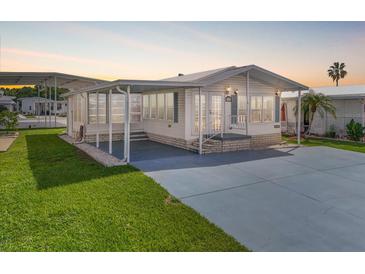 Charming single-story home with a covered porch, well-maintained lawn, and paved driveway at 35045 Cynthia Ave # 35945, Zephyrhills, FL 33541