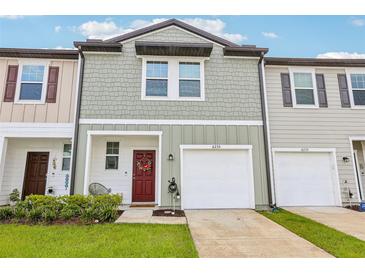 Charming townhome with attached garage, neutral siding, and well-maintained front lawn at 6235 Bucket Ct, Gibsonton, FL 33534