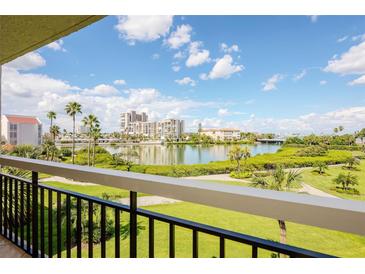 Enjoy breathtaking water views from this balcony, framed by lush greenery and clear skies at 7893 Sailboat Key S Blvd # 304, South Pasadena, FL 33707