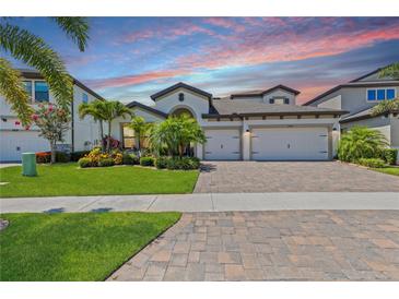 Charming single-Gathering home showcasing a well-manicured lawn, mature landscaping and a three-car garage at 12607 Pensacola Ct, Riverview, FL 33579