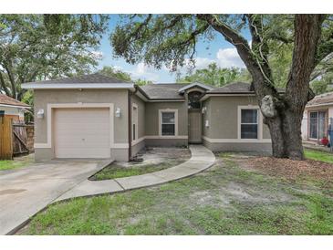 Charming single-story home with stucco exterior, garage, and mature landscaping at 1605 Prescott S St, St Petersburg, FL 33712