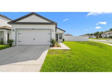 Charming single-Gathering home with a well-manicured lawn, attached garage, and inviting curb appeal at 29245 Fedora Cir, Brooksville, FL 34602