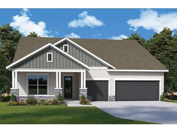 Charming home featuring stone accents, a covered entry, two-car garage, and well-manicured front lawn at 31504 Hayman Loop, Wesley Chapel, FL 33545
