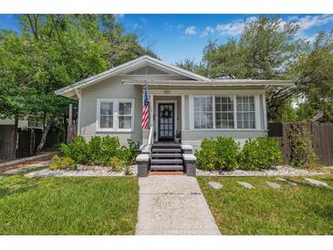 Charming single-story home featuring a well-manicured lawn and inviting front porch at 5101 N Suwanee Ave, Tampa, FL 33603