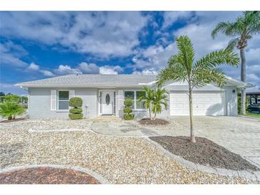 Charming single-story home with well-manicured landscaping and a paved driveway at 805 Leisey Cir, Ruskin, FL 33570