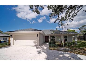 Charming single-story home with a well-maintained front yard and an attached two-car garage at 1536 Palmetto St, Clearwater, FL 33755