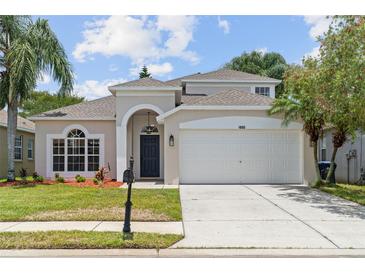 Charming two-story home with well-manicured lawn, a two-car garage, and beautiful landscaping at 1800 Loch Haven Ct, Trinity, FL 34655