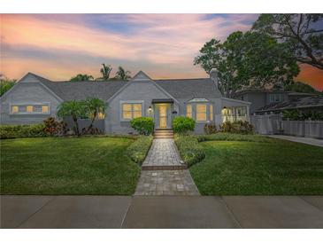 Charming single-story home featuring a meticulously landscaped front yard and welcoming brick walkway at 555 21St Ne Ave, St Petersburg, FL 33704