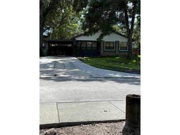 Charming single-story home with stone accents, large windows, and a convenient covered carport at 5608 N River Shore Dr, Tampa, FL 33603