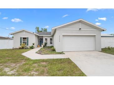Charming single-story home featuring a two-car garage and a well-manicured front yard with a tidy walkway at 9429 Northcliffe Blvd, Spring Hill, FL 34606