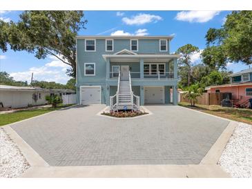 Beautiful two-story home featuring a charming front porch and a spacious driveway at 132 Pennsylvania Ave, Palm Harbor, FL 34683
