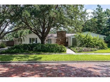 Charming single-story home featuring stone accents, mature landscaping, and a brick-paved street at 211 60Th S Ave, St Petersburg, FL 33705