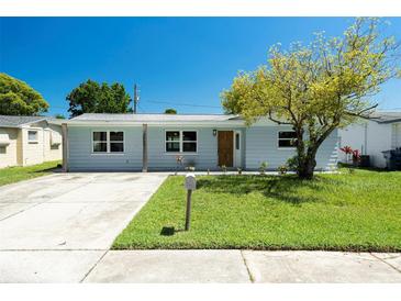 Charming single-story home with a well-maintained lawn and a welcoming facade under a clear blue sky at 3509 Brookston Dr, Holiday, FL 34691