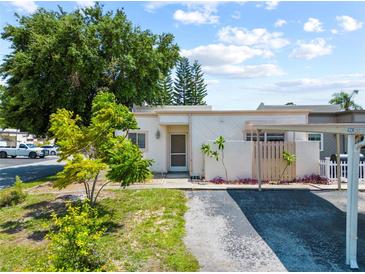 Charming single-story home with lush landscaping and a covered parking area at 4326 Fern Glen St, Holiday, FL 34691