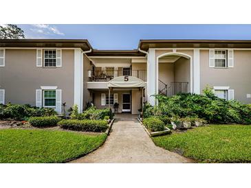 Charming condo featuring a well-maintained exterior with a front yard with lush landscaping at 5265 E Bay Dr # 521, Clearwater, FL 33764