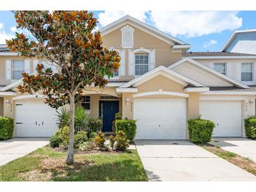 Charming townhome features a well-manicured lawn, attached garage, and a welcoming front entrance at 9630 Carlsdale Dr, Riverview, FL 33578