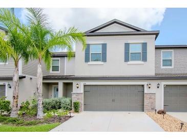 Charming two-story townhouse with a two-car garage and well manicured lawn at 1674 Roseville St, Lutz, FL 33549