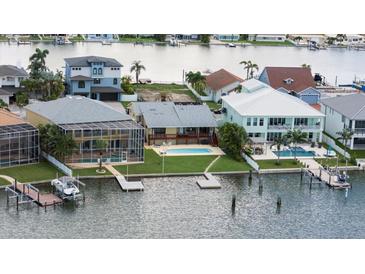 Waterfront homes feature docks, pools, and lush landscaping in this desirable coastal community at 17025 Dolphin Dr, North Redington Beach, FL 33708