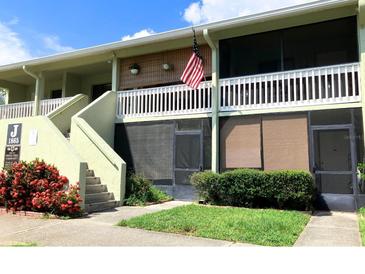 Charming condo exterior with private screened porch and well maintained landscaping at 1865 Mazo Manor # 1, Lutz, FL 33558