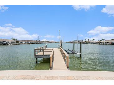 Stunning waterfront property featuring a private boat dock and lift, perfect for the avid boater at 384 Boca Ciega Point Blvd, St Petersburg, FL 33708