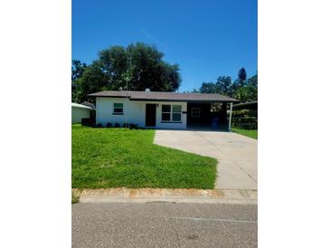 Charming single-story home featuring a welcoming front yard and convenient carport at 5627 Commonwealth N Ave, St Petersburg, FL 33703