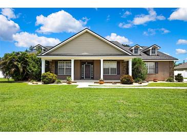 Charming single-Gathering home featuring a large front yard, well-maintained lawn and landscaping at 22431 Panther Run Ct, Land O Lakes, FL 34639