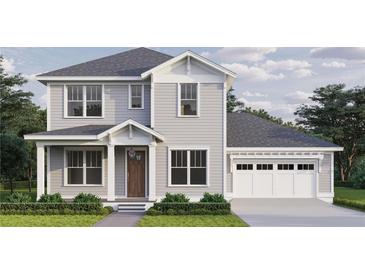Charming two-story home featuring a light gray exterior, attached garage, and professionally landscaped front yard at 0 4Oth N Ave, St Petersburg, FL 33703