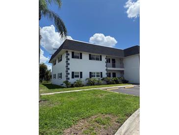 Well-maintained two-story building with lush landscaping and clearly marked parking spaces at 102 47Th Avenue W Dr # 136, Bradenton, FL 34207