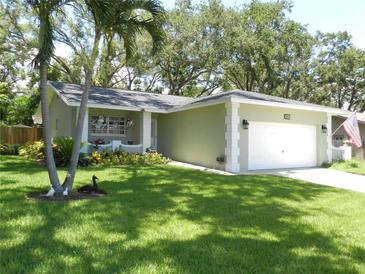 Charming single-story home featuring a well-manicured lawn and tasteful landscaping at 1212 Rosewood St, Largo, FL 33770