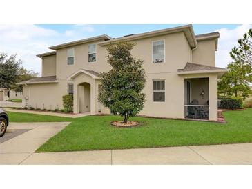Charming townhouse featuring a well-manicured lawn and covered entryway at 1976 Marlington Way, Clearwater, FL 33763