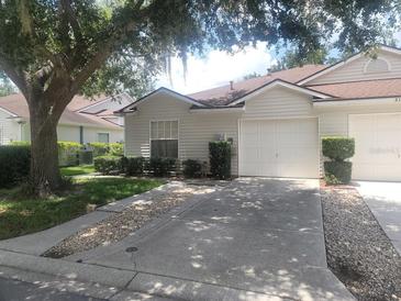 Charming single-story home with a well-maintained lawn and attached one-car garage at 21544 Clubside Loop, Lutz, FL 33549