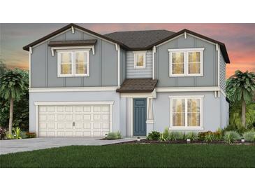 Charming two-story home with a gray exterior, a two car garage, and a well-manicured lawn at 36458 Sespe Creek Ct, Zephyrhills, FL 33540