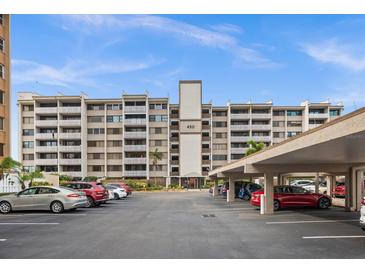 Multi-story condo building featuring balconies, covered parking, and well-maintained landscaping at 450 Treasure Isle Causeway # 411, Treasure Island, FL 33706