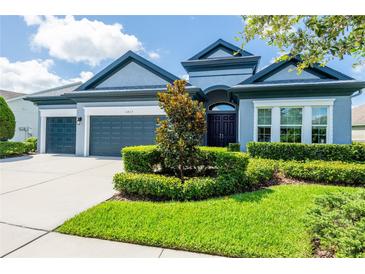 Charming single-story home featuring a well-maintained lawn and a two-car garage at 6817 Ebb Tide Ave, Apollo Beach, FL 33572