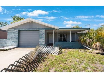Charming single-story home featuring a garage and a welcoming front porch at 6834 Mesa Verde St, Port Richey, FL 34668