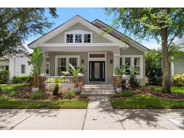 Charming home featuring manicured landscaping, neutral paint, and a welcoming covered porch entry at 10021 Brompton Dr, Tampa, FL 33626