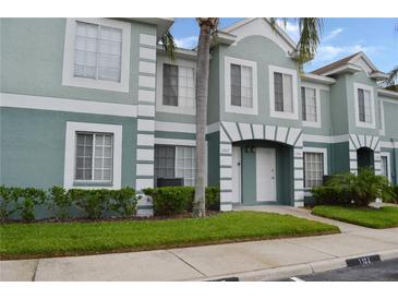 Inviting condo featuring a charming exterior with well-maintained landscaping, set under a clear blue sky at 1302 Twilridge Pl, Brandon, FL 33511