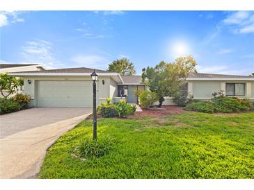 Charming single-story home features a well-manicured lawn and a two-car garage at 1306 Idlewood Dr # 53, Sun City Center, FL 33573