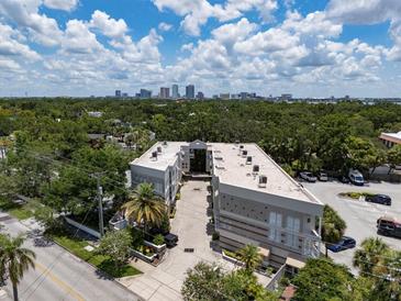 Aerial view showcasing the building's architecture and location with downtown views and ample parking at 1508 S Howard Ave # A, Tampa, FL 33606