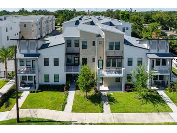 Modern townhome with balconies, manicured lawn, and fresh landscaping in a desirable community at 2568 13Th N Ave # 2568, St Petersburg, FL 33713