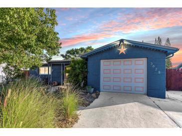 Charming single Gathering home features an attached garage, nicely landscaped front yard, and lovely exterior paint at 3628 Holiday Lake Dr, Holiday, FL 34691
