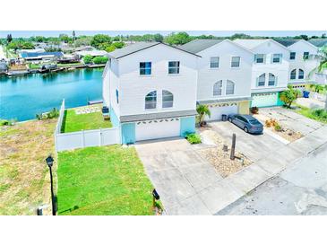 Stunning waterfront home with a well-manicured lawn, private dock, and two-car garage at 5253 Boardwalk St, Holiday, FL 34690