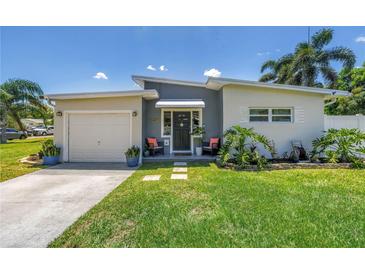Charming single Gathering home featuring a well maintained lawn and welcoming front entry way at 5401 7Th N Ave, St Petersburg, FL 33710