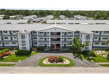 An inviting condominium building with well-maintained landscaping and a circular driveway at 6000 20Th N St # 123, St Petersburg, FL 33714