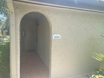Welcoming front entrance featuring a unique archway and house number at 6262 142 N Ave # 1001, Clearwater, FL 33760