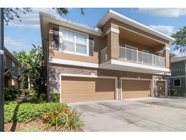Charming townhome with a two-car garage, balcony, and stone accents at 7001 Interbay Blvd # 219, Tampa, FL 33616